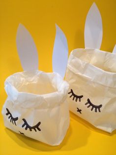 two paper bags with bunny ears and eyelashes on them