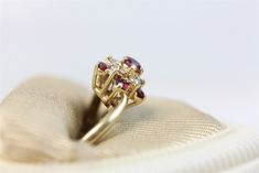 N6250 Vintage 14K Yellow Gold Diamond Ruby Cluster Ring Cocktail Gemstone Luxury (6.75) BRILLIANT NATURAL GEMSTONES SET IN SOLID 14KT GOLD. AMAZING RING WONDERFUL HIGHEST QUALITY. JUST PART OF MY MOST RECENT ESTATE FINDS! FOLLOW ME TO SEE THEM ALL! Metal: 14K Yellow Gold Metal Purity: 14k Material: Diamond Ruby Ring Size: 6.75 Other Dimensions: 9.8mm W Form: Cluster Ring Cocktail Gemstone Luxury Age: Vintage Weight (Grams): 4 IT IS IN EXCELLENT ESTATE CONDITION ALL ITEMS LISTED AS GOLD ARE EITHE Gold Multi-stone Cluster Ring For Anniversary, Cluster Ruby Ring In Yellow Gold, Yellow Gold Cluster Ruby Ring, Gold Ruby Cluster Ring, 14k Gold Cluster Ring For Formal Occasions, Elegant 14k Gold Ruby Cluster Ring, Elegant 14k Gold Cluster Ruby Ring, Gold Cluster Ruby Ring For Wedding, Gold Cluster Ring With Gemstone