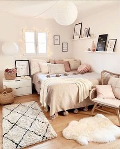 a living room filled with lots of furniture and pictures on the wall above it's bed