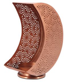 an artisticly designed copper plated candle holder with holes in the middle and sides