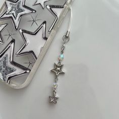 "Cyber Star" Phone Charm     Length is around 5 inches, made with stainless steel wire, glass and metal beads Perfect y2k chrome touch to any bags, phones, kpop binders, and ohh they look so good on digi cams <3    Each product is handmade, so slight variations may occur! PHONE CHARM CARE! - Please keep in mind that all of my phone charms are intended to be used as an ACCESSORY and NOT to hold your phone. - Excessive pulling on phone charms may result in breakage - I am not responsible for any d Phone Charms Strap, Y2k Chrome, Phone Keychain, Phone Chains, Y2k Phone, Electric Guitar Design, Gelang Manik-manik, Silver Keychain, Gelang Manik