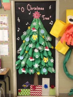 a christmas tree made out of rolled up paper on the door to a classroom room