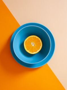 an orange slice is in a blue bowl