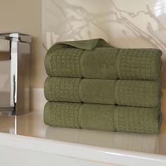 four green towels stacked on top of each other