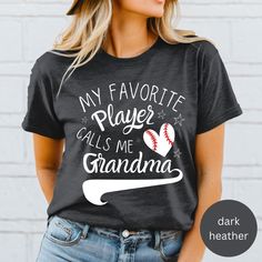 Introducing our Baseball Grandma T-shirt, made for Comfort and Style!  :-) DESIGN: This t-shirt features an image of a baseball in the shape of a heart along with the text, "My Favorite Player Calls Me Grandma" text, sure to show your love for your grandkids! *For personalization to include your grandchild's name on the sleeve, click here:  https://www.etsy.com/listing/1709662462/personalized-baseball-grandma-customized :-) VIBRANT COLORS: Made with high-quality, vibrant ink, the colors on this Black Tops With Name Print For Baseball Season, Gray Sports Top With Text Print, Gray Crew Neck Top For Sports Events, Sports Fan Tops With Letter Print For Sports Season, Sports Fan Tops With Screen Print For Baseball Season, Gray Sports Top With Sublimation Print, Gray Fan Apparel Tops For Sports Events, Gray Short Sleeve Tops For Sports Season, Game Day Tops With Sublimation Print Short Sleeve