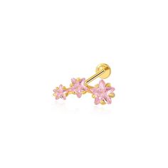 a pair of gold and pink crystal flower ear piercings on a white background with reflection