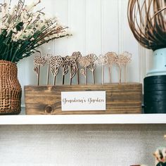 there is a wooden box with some flowers in it on the shelf next to other items