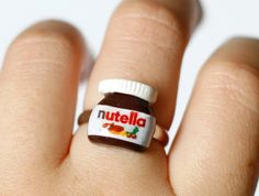 a person's hand with a nutella ring on it