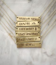 Personalize this gold bar necklace with any word that has special meaning to you or to a loved one! Give a word of encouragement to someone going through a hard time - "BRAVE" Remind her how valuable she is - "PRICELESS"Does she light up your day? If so, tell her! - "SHINE"Going on a trip? - "WANDER"Remind her it's gonna be ok. Keep your chin up - "HOPE"● 16" chain ● Completely customizable! Just message me!● Bar measures 40x8mm● Solid brass bar● Gold filled chain● Handmade by Stuart & Lisa Meaningful Custom Name Necklaces For Everyday, Custom Name Necklace For Everyday Use, Everyday Hand Stamped Rectangular Necklace, Everyday Rectangular Hand Stamped Necklace, Inspirational Hand Stamped Everyday Necklace, Meaningful Everyday Gold Name Necklace, Everyday Inspirational Hand Stamped Necklaces, Everyday Inspirational Hand Stamped Necklace, Everyday Engraved Meaningful Charm Necklaces