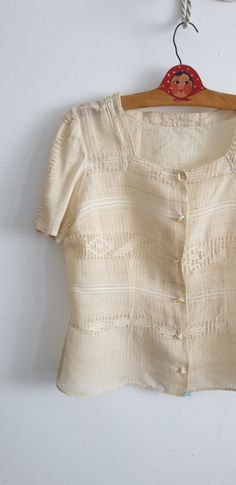 "Vintage 1930s -1940s raw silk thread known in Romania as borangic blouse with square neckline, short sleeves and closes with snaps. -- M E A S U R E M E N T S --- fits like: small/ medium bust: 38\" waist: 33\" length: 22\" brand/maker: n/a condition: excellent see last photo Shipping Is Avaliable Worldwide. Every item is carefully shipped Priority via Air Mail - shipping takes from 7 to 14 working days, depending on your location. Shipping includes Tracking. Come and check out our shop to see Vintage Square Neck Blouse For Spring, Fitted Cream Linen Blouse, Fitted Linen Cream Blouse, Vintage Square Neck Tops For Spring, Fitted Vintage Blouse With Square Neck, Vintage Square Neck Blouse For Summer, Vintage Beige Linen Blouse, Vintage Linen Blouse With Buttons, Vintage Linen Blouse For Summer