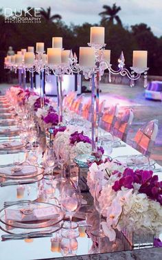 a long table is set up with candles and flowers for an elegant dinner or reception