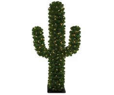 a large cactus shaped plant with lights on it's sides and the top part of its trunk