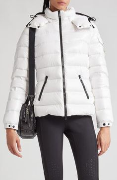 Whether you're headed somewhere metropolitan or mountainous, you'll stay warm in this sporty down puffer made from Moncler's water-resistant lacquered nylon. Elasticized cuffs and a detachable drawcord hood provide extra protection from the elements. Two-way front-zip closure Stand collar; removable drawcord hood Elastic cuffs with adjustable snap tab Front zip pockets; sleeve snap-flap pocket Lined, with down fill 100% polyamide Dry clean or machine wash, line dry Imported Designer Clothing White Nylon Puffer Jacket With Padded Collar, White Sporty Puffer Jacket With Padded Collar, Luxury Down Puffer Jacket For Outdoor, White Duck Down Puffer Jacket With Padded Collar, Luxury Puffer Jacket For Outdoor Fall Use, White Puffer Jacket With Zipper For Outdoor, Luxury Puffer Jacket For Fall Outdoor, White Outdoor Puffer Jacket With Zipper Closure, Luxury White Puffer Jacket With Padded Collar