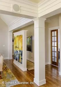 a large living room with white walls and wood flooring is pictured in this image