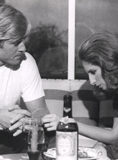 a man sitting next to a woman at a table