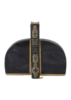 two books sitting on top of each other in front of a white background with gold trim