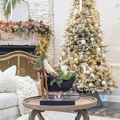 a living room decorated for christmas with a tree in the corner and other holiday decorations