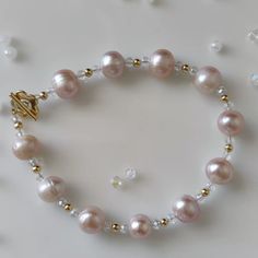 NEXT DAY SHIPPING Natural freshwater pearl bracelet, the color of the pearl is natural, a very pink and pink, which is very suitable for young girls. The design of the bracelet is decorated with Austrian crystals, which makes the whole bracelet look crystal clear and transparent. Very cute, this summer jewelry, when you put it on, it shimmering in the sun, very eye-catching Pearls are birthstones, this bracelet is perfect Please don't hesitate to contact me with any questions at all. View more items in my shop      https://www.etsy.com/shop/TTanGadgets All images are copyrighted by TTANGADGETS . All rights reserved Pearl Crystal Bracelet With Pearl Charm As Gift, Feminine Pearl Bracelets As Gift, Feminine Pearl Bracelet For Gifting, Handmade Delicate Pearl Bracelets, Delicate Handmade Pearl Bracelets, Handmade Pearl Bracelet Perfect For Gifts, Dainty Pearl Beaded Bracelets For Party, Handmade Pearl Bracelet For Gift, Handmade Pearl Bracelet Gift