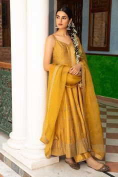 Mustard anarkali with floral motif zari embroidery. Comes with silk pant and dupatta.
Component: 3
Pattern: Embroidered
Type Of Work: Floral Motifs
Neckline: V-Neck
Sleeve Type: Sleeveless
Fabric: Anarkali and Pant: Silk, Dupatta: Organza
Color: Yellow
Other Details: 
Floral motif embroidery
Sheer dupatta
Occasion: Mehendi and Haldi - Aza Fashions Pakistani Maxi, Pakistani Maxi Dresses, Sleeveless Anarkali, Maxi Frocks, Floral Anarkali, Yellow Anarkali, Eid Dress, Embroidered Anarkali, Eid Dresses