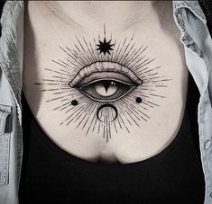 a woman's chest with an all seeing eye tattoo