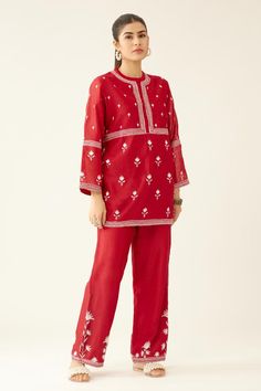 Red short kurta with silk thread embroidery in floral pattern and round neckline. Paired with straight pant.
Components: 2
Pattern: Embroidery
Type Of Work: Thread, floral
Neckline: Round
Sleeve Type: Three quarter
Fabric: Silk Chanderi
Color: Red
Other Details: 
Lined
Embroidery on pant hem
Elasticated waist at the back
Side pockets
Closure: Pant: Drawstring
Occasion: Work - Aza Fashions Red Floral Embroidered Sets For Navratri, Red Sets With Floral Embroidery For Navratri, Traditional Straight Kurta Pant Set With Embroidered Border, Red Floral Embroidered Palazzo Set For Navratri, Red Floral Embroidered Palazzo Set For Festivals, Red Floral Embroidery Palazzo Set For Festivals, Red Floral Embroidered Sets For Eid, Red Palazzo Set With Embroidered Border And Straight Kurta, Red Palazzo Set With Straight Kurta And Embroidered Border