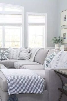 a living room filled with furniture and windows