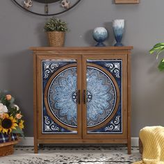 a blue and white cabinet sitting in front of a clock