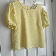 Boutique Blouse Yellow Crinkle Gauze Look Puff Shoulder Elastic Sleeve Button Back Closure Spring Trendy Blouse With Crinkle Texture, Trendy Spring Blouse With Crinkle Texture, Textured Puff Sleeve Summer Tops, Textured Puff Sleeve Tops For Summer, Summer Textured Puff Sleeve Tops, Chic Crinkle Texture Blouse For Day Out, Spring Blouse With Crinkle Texture For Daywear, Yellow Puff Sleeve Blouse For Brunch, Yellow Puff Sleeve Blouse For Day Out