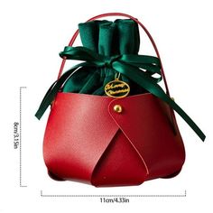 a red leather bag with a green ribbon around it