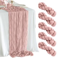 the table is set with pink and white linens