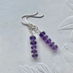 Sterling silver Amethyst earrings featuring purple Amethyst rondelles and sterling silver shepherd hooks. They are a really lovely pair of earrings that are suitable for any occasion.  Amethyst is February's birthstone and is a recommended gift for both 2nd and 6th wedding anniversaries.  It is associated with the astrological signs of Aquarius and Leo and represents the Crown Chakra. * Each earring measures approximately 4.5mm in length * The Amethyst rondelles measure approximately 4mm x 6mm T Faceted Amethyst Earrings As A Gift, Faceted Amethyst Earrings For Gift, Adjustable Lavender Sterling Silver Earrings, Hypoallergenic Lavender Sterling Silver Jewelry, Silver Amethyst Crystal Earrings With Ear Wire, Nickel-free Purple Crystal Earrings In Sterling Silver, Purple Earrings With Ear Wire For Anniversary, Purple Hook Earrings For Anniversary, Purple Faceted Earrings For Anniversary