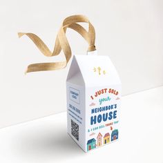 a cardboard box with a ribbon tied around it that says, just sold your neighbor's house