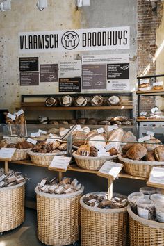 breads and pastries are on display in baskets