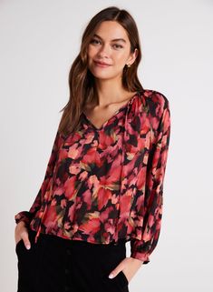 This shirred raglan tie front floral blouse is a versatile long sleeve top featuring a flattering v-neckline, perfect for any occasion. With a flowy fit, this blouse is comfortable to wear and easy to style, making it a must-have piece for your wardrobe this season. Ideal for both casual and dressy looks, this top is a timeless addition to any outfit. 100% Rayon Bella Dahl, Cardigan Sweater Dress, Tie Front Blouse, Sweater Gift, Dress The Population, Sweater Sale, Sheer Fabrics, Floral Blouse, Jacket Tops