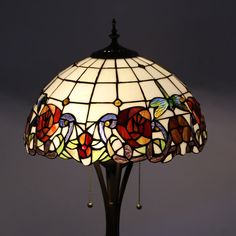 a stained glass lamp on a wooden stand