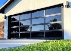 an image of a garage door with grass in the foreground