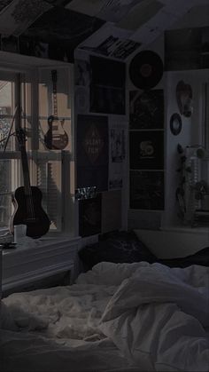 a bedroom with a guitar on the window sill