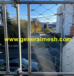 a car is parked behind a chain link fence