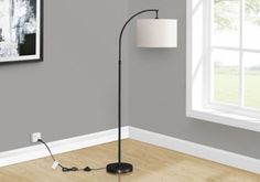 the floor lamp is next to an empty room