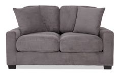 a gray couch with four pillows on it