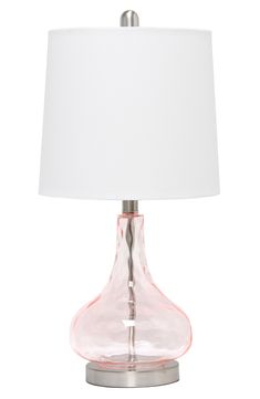 a pink glass table lamp with a white shade on the bottom and a silver base