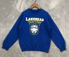 Vintage Lakehead University Sweatshirt Lakehead Track & Field Crewneck Blue University College Sweater Sports Unisex Size S  REF : NS1429 -THIS IS USED VINTAGE ITEM, PLEASE DONT EXPECT CONDITION WILL BE LIKE NEW. -ANY DEFECT ON ITEM WILL BE PROVIDE ON PHOTO. -PLEASE ASK ME IF HAVE ANY DOUBTS ABOUT THIS ITEM EXPECIALLY SIZE MEASUREMENT SIZE  : S CONDITION : GOOD CONDITION.PLEASE REFER PHOTO PHOTO FOR MORE DETAILS. PIT (ARMPIT TO ARMPIT): 21.5 INCH LENGTH ( TOP TO BOTTOM) : 26.5  INCH  SLEEVE : 23 INCH MATERIAL: COTTON AND POLYESTER  SHIPPING : IM USING DHL EXPRESS FOR SHIPMENT.TRACKING NUMBER WILL BE PROVIDE AFTER ITEM PICK UP BY COURIER. PROCESSING TIME : 1-3 BUSINESS DAYS Blue Team Sweatshirt For Fall, Blue Team Name Sweatshirt For Fall, Blue Graphic Print Sweatshirt For Sports Events, Blue Sweatshirt For Sports, Blue Sweatshirt For Sports Season, Blue Sweatshirt For Fall Sports Events, Blue Sweatshirt For Sports Events In Fall, Collegiate Blue Sweatshirt For Sports Season, Blue Collegiate Sweatshirt For Sports Events