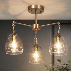 three lights hanging from a ceiling fixture in a room