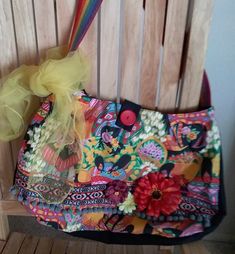 Large 13x20 bag in vivid Mexican colors featuring Mexican women at flower market. Has rainbow strap, button closure, and decorated with braid, ball fringe and flowers. Fun Multicolor Crossbody Shoulder Bag, Fun Multicolor Bags With Removable Pouch, Fun Multicolor Shoulder Bag With Adjustable Strap, Mexican Colors, Mexican Bag, Mexican Women, Flower Market, Purses And Handbags, Shoulder Bags