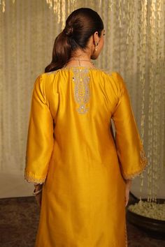 Mustard silk chanderi kurta with thread embroidered paisley patterns embellished by sequins. Comes with matching tulip dhoti pant.
Components: 2
Pattern: Embroidered
Type Of Work: Thread, Sequin
Neckline: V-neck
Sleeve Type: Three quarter
Fabric: Kurta: Silk Chanderi, Tulip Dhoti: Bamberg Satin
Color: Yellow
Other Details: 
Straight silhouette
Occasion: Sangeet,Mehendi and Haldi - Aza Fashions Traditional V-neck Semi-stitched Salwar Kameez, Fitted Silk V-neck Set, Traditional V-neck Sharara For Eid, Bollywood Style V-neck Sharara For Eid, Elegant V-neck Kurta For Festive Occasions, Elegant V-neck Traditional Wear With Pallu, Transitional Silk Kurta With Dabka Detailing, Festive V-neck Salwar Kameez With Zari Work, Diwali V-neck Sharara With Resham Embroidery