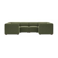 a green sectional couch sitting on top of a white floor