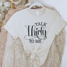 a white t - shirt that says talk whirly to me on the front