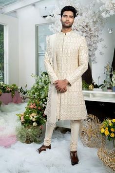 Ivory sherwani with floral zardozi embroidery and band collar. Comes with churidar and stole.
Components:3
Pattern:Embroidery
Type of Work:Zardozi
Neckline:Band
Sleeve Length:Full
Fabric:Twill Silk and Cotton Lycra
Color:White
Other Details:
Stole with embroidered border
Side slits
Closure: Concealed button front
Occasion:Groom - Aza Fashions Varun Chakkilam, Sherwani Groom Wedding, Stole For Men, Ivory Sherwani, Kunal Rawal, Black Sherwani, Blue Sherwani, Embroidered Sherwani, Sherwani Groom