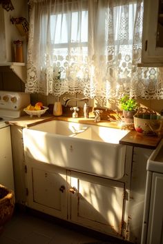 an old kitchen sink in front of a window with white lace curtains on the windowsill