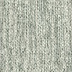 an upholstered fabric textured in light green and white